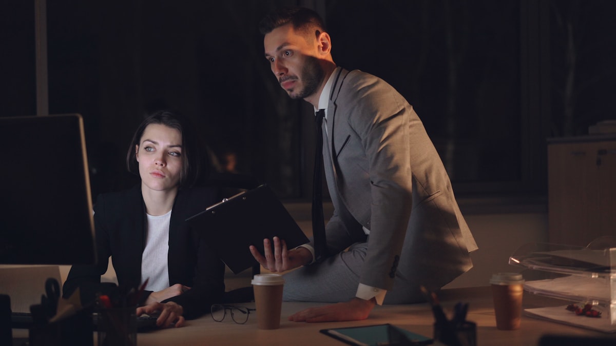 Two people reviewing a process on screen