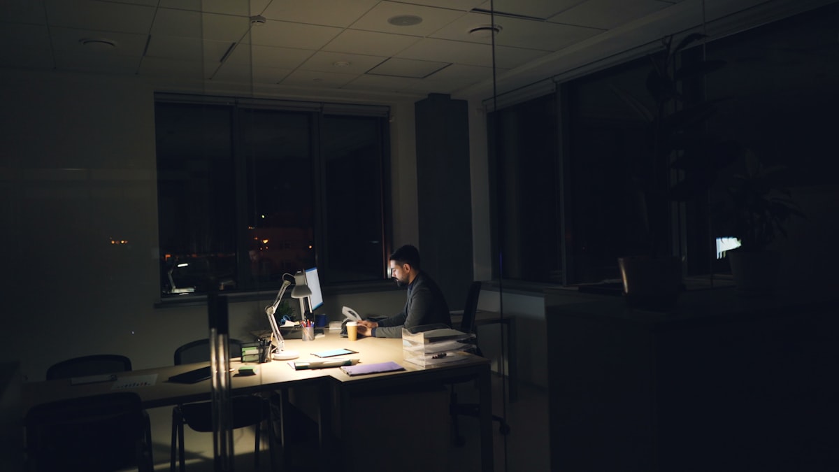 Someone working late at a lit desk